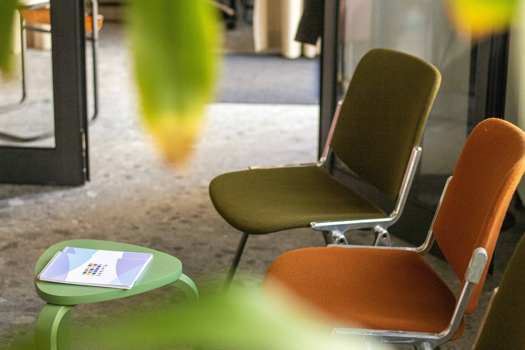 Olive and orange chairs in the space