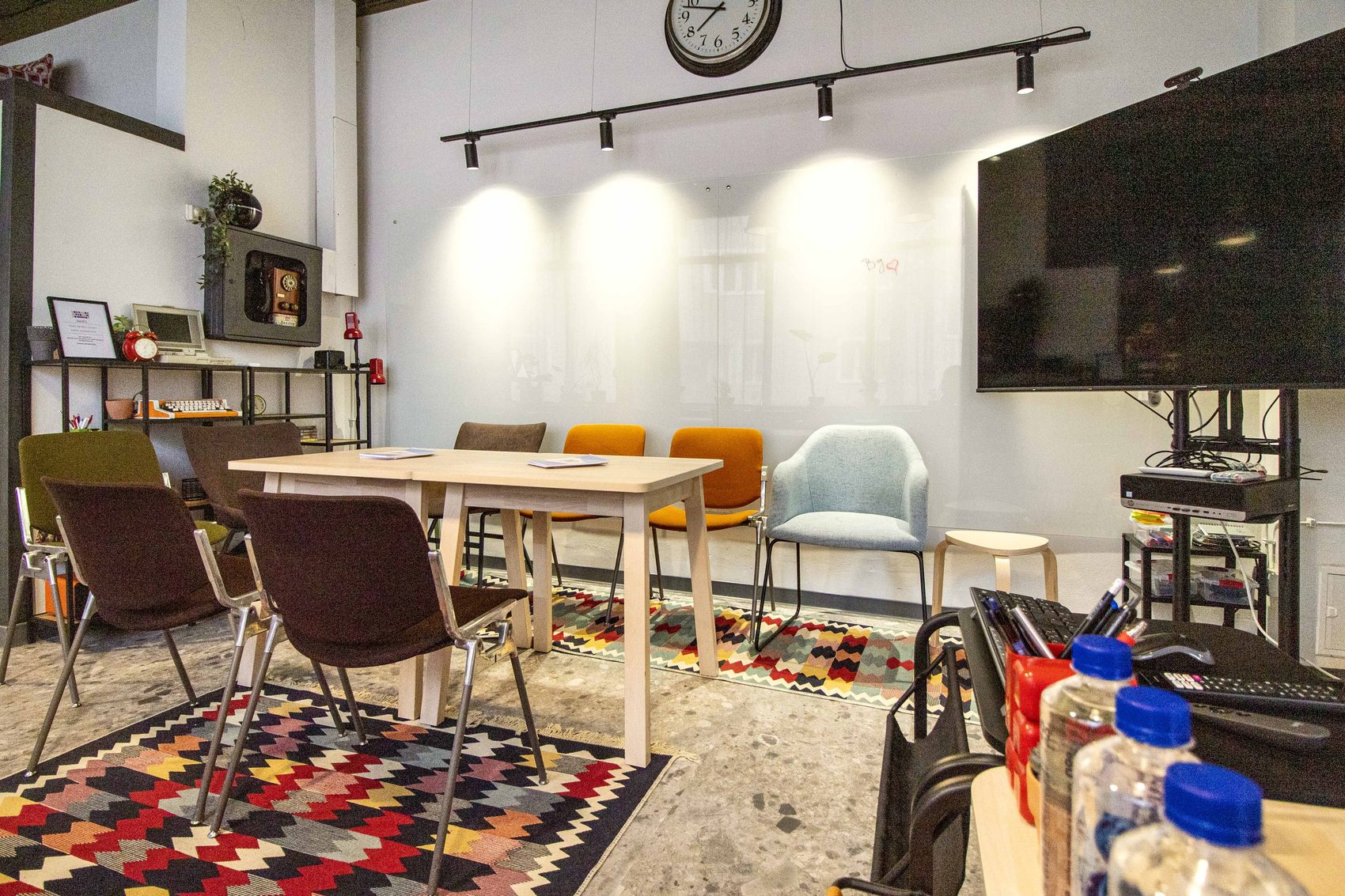 Meeting room with TV screen and wall clock